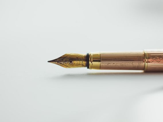 Gouden pen op papier